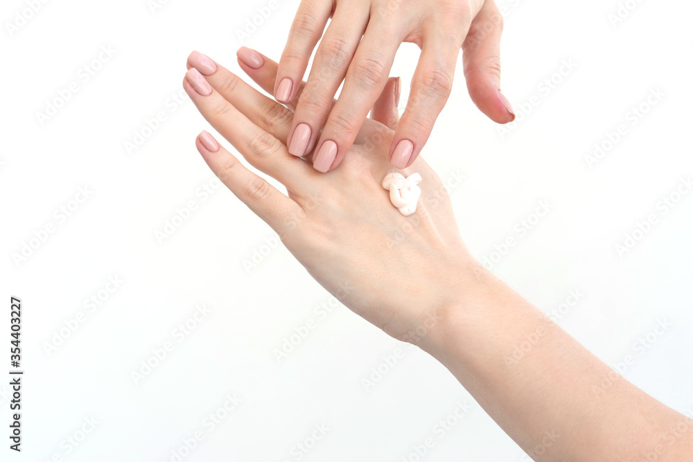 Close-up of a drop of cream on female hands. Moisturizing hands. Skin care on a white background Close-up of a drop of cream on female hands. Moisturizing hands. Skin care on a white background