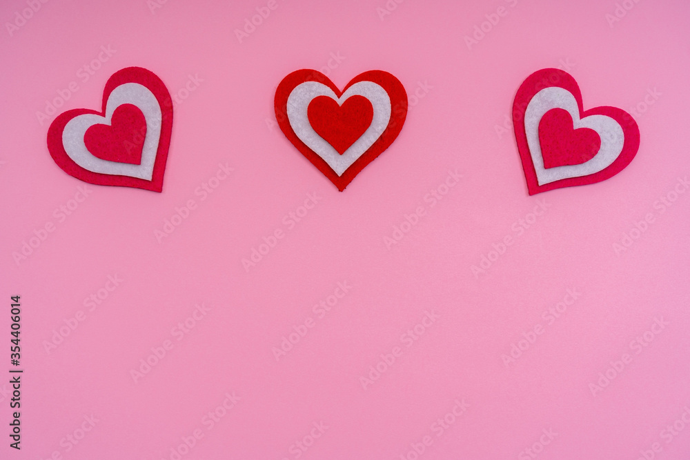 Horizontal red hearts on a pink background. Conceptual photo. Copy space.