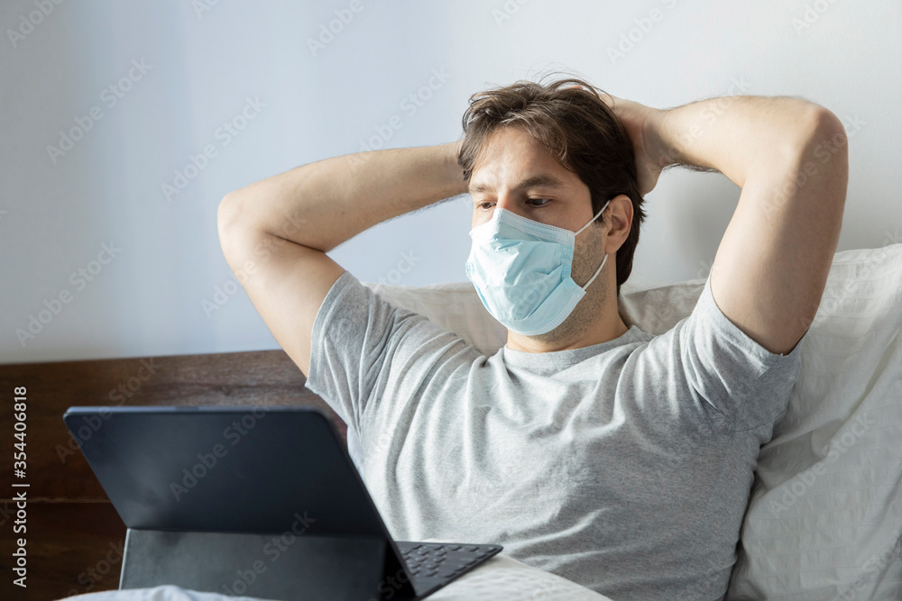 Man working in bed, doing home office because he is sick. Man working in bed, doing home office because he is sick.