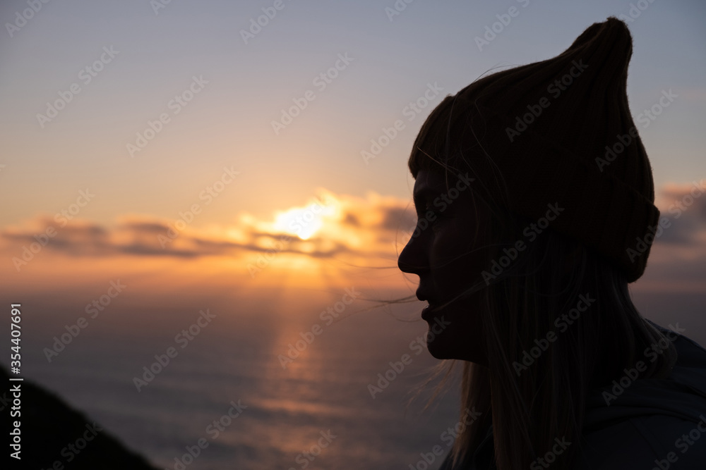 Silhouette of a beautiful woman looking at the sunset Silhouette of a beautiful woman looking at the sunset