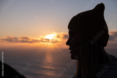 Silhouette of a beautiful woman looking at the sunset