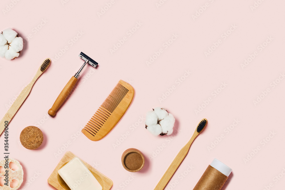Bathroom accessories on pink background. Natural bamboo toothbrushes, sponge, cotton flowers, shaving brush and soap. Bathroom accessories on pink background. Natural bamboo toothbrushes, sponge, cotton flowers, shaving brush and soap.