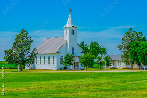 Photos A small old fashioned white chapel sits in a peaceful green meadow in Texas