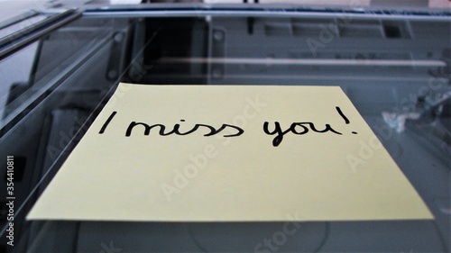Closeup of handwritten "I Miss You!" note on a copier