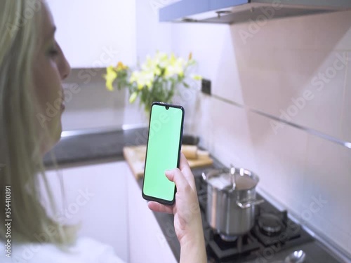 Girl using the phone Green display on the cosciana, Hands holding the CHROME KEY business smartphone Fingers of the modern display smartphone touching scrolling massage functions