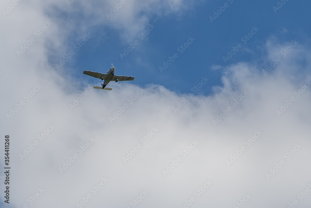 small white plane flies in the sky small white plane flies in the sky