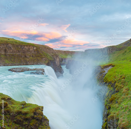 Breathtaking summer sunrise on Gullfoss Waterfall. Colorful morning scene of Iceland, Europe. Midnight sun of Iceland. Visit Iceland. Beauty world.