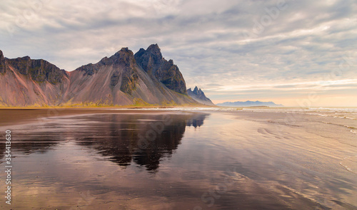 Fantastic panorama of Mount Vestrahorn at low tide at sunrise. Incredible summer morning on the Stokksnes headland. Southeastern Iceland  Europe. Visit Iceland. Beauty world.