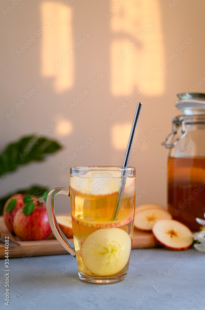Homemade fermented kombucha or cider with ice in a tall glass cup. Healthy probiotic refreshing non-alcoholic cocktail. Copy space. Homemade fermented kombucha or cider with ice in a tall glass cup. Healthy probiotic refreshing non-alcoholic cocktail. Copy space.