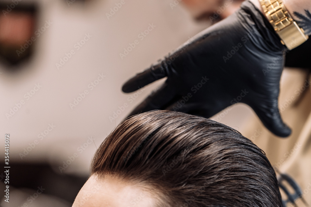 Fototapeta premium Men's haircut in a barbershop. Styling and hair care. 