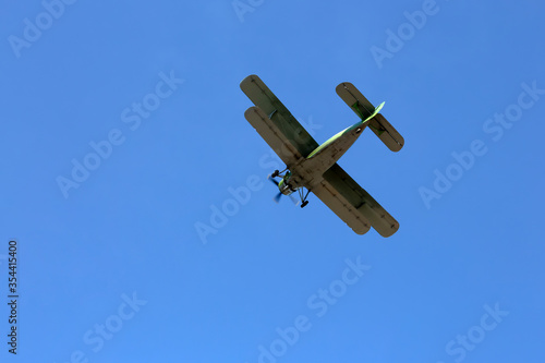 Retro military plane flies in the sky. Russia.