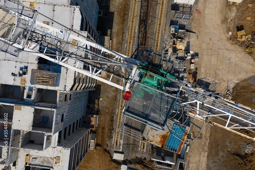 Construction site with cranes. Construction workers are building. Aerial view.