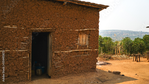 old local traditional house in Rwanda, made of animals' dung, clay and hay, poverty in Africa, primitive homes, real life in Eastern Africa, poor simple settlements in villages
