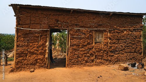 old local traditional house in Rwanda, made of animals' dung, clay and hay, poverty in Africa, primitive homes, real life in Eastern Africa, poor simple settlements in villages

