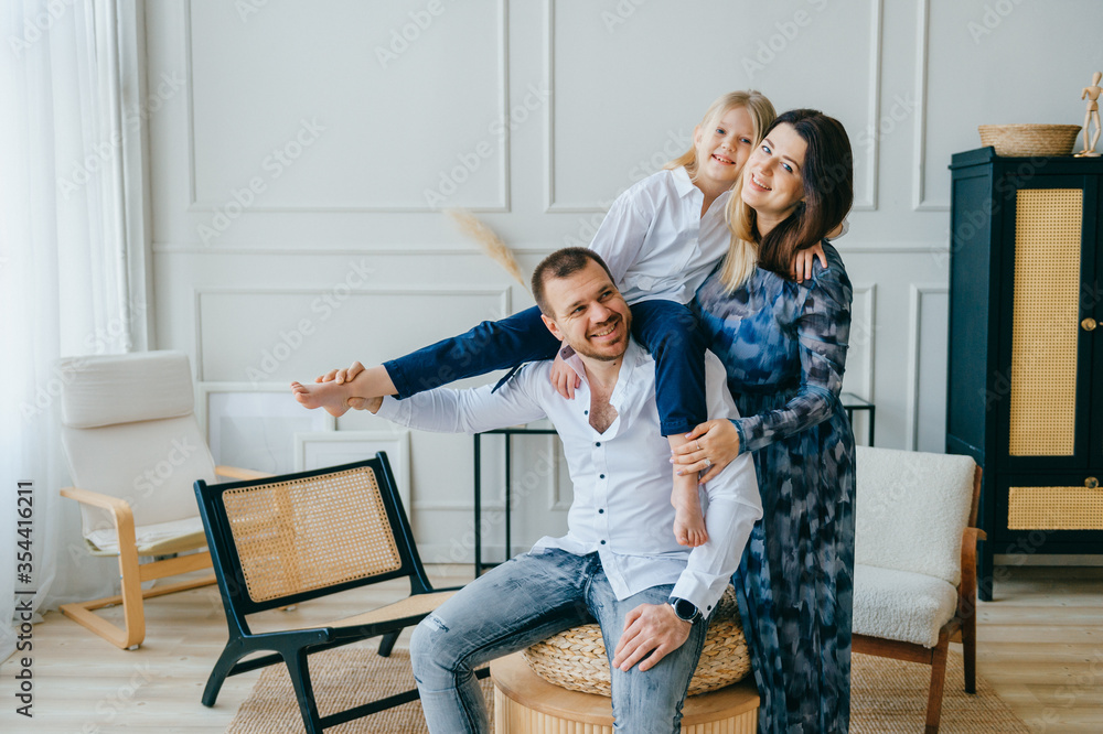 Cheerful parents plays with their child at home Cheerful parents plays with their child at home