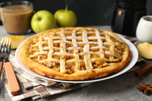Composition with apple pie and ingredients on gray background. Homemade food