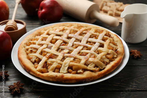 Composition with apple pie and ingredients on wooden background. Homemade food