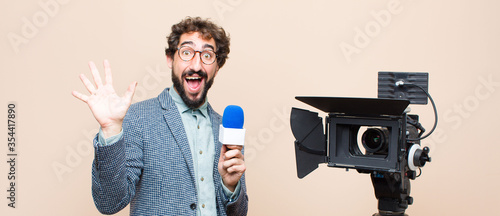 Bild auf Leinwand television presenter smiling happily and cheerfully, waving hand, welcoming and