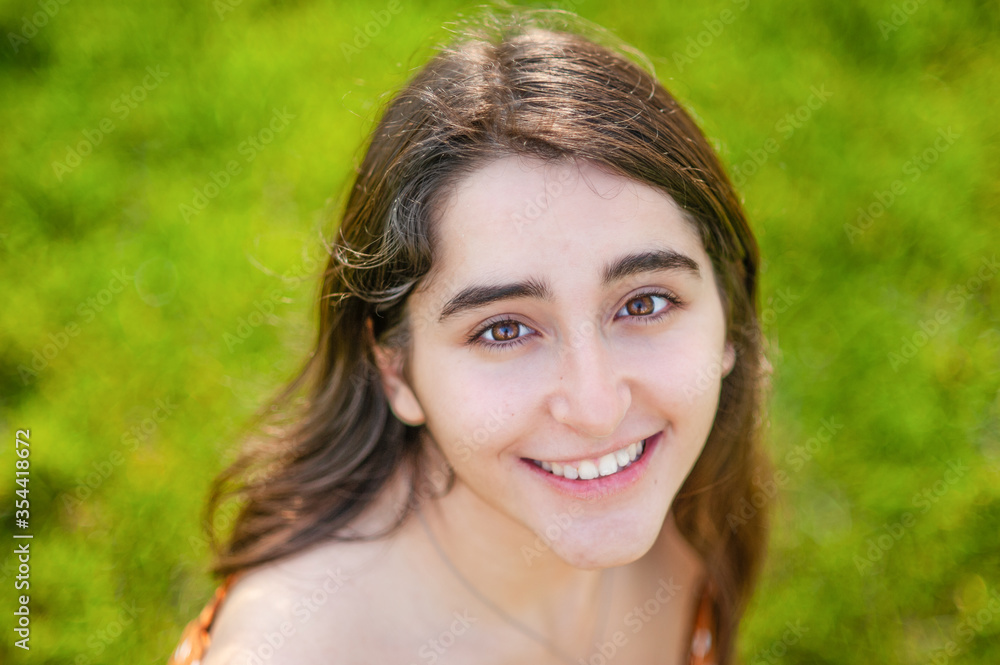 high angle view of a beautiful caucasian girl in a green background. Great copy space high angle view of a beautiful caucasian girl in a green background. Great copy space