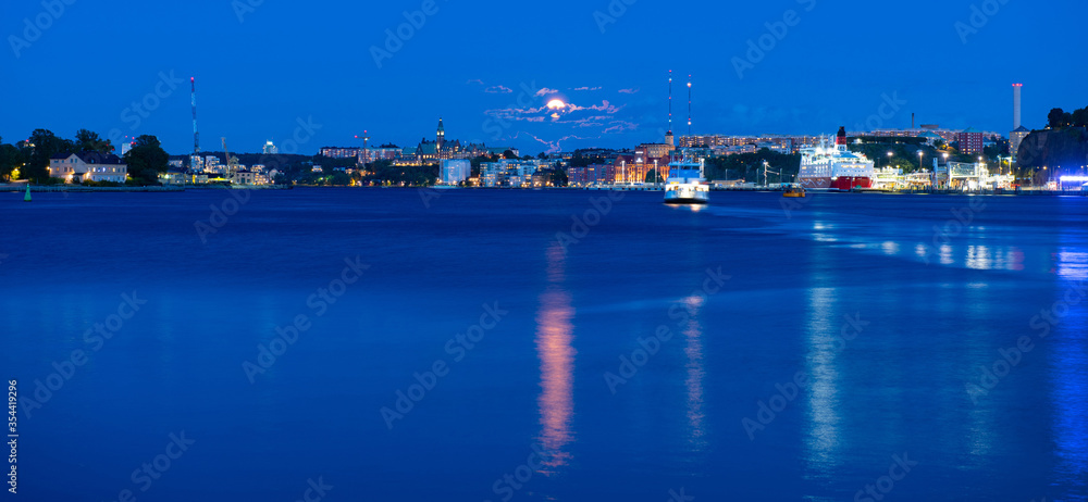 Beautiful sea view on Stockholm in dusk and ferry floating at Baltic Sea, Sweden. Moonlight sky. Beautiful sea view on Stockholm in dusk and ferry floating at Baltic Sea, Sweden. Moonlight sky.