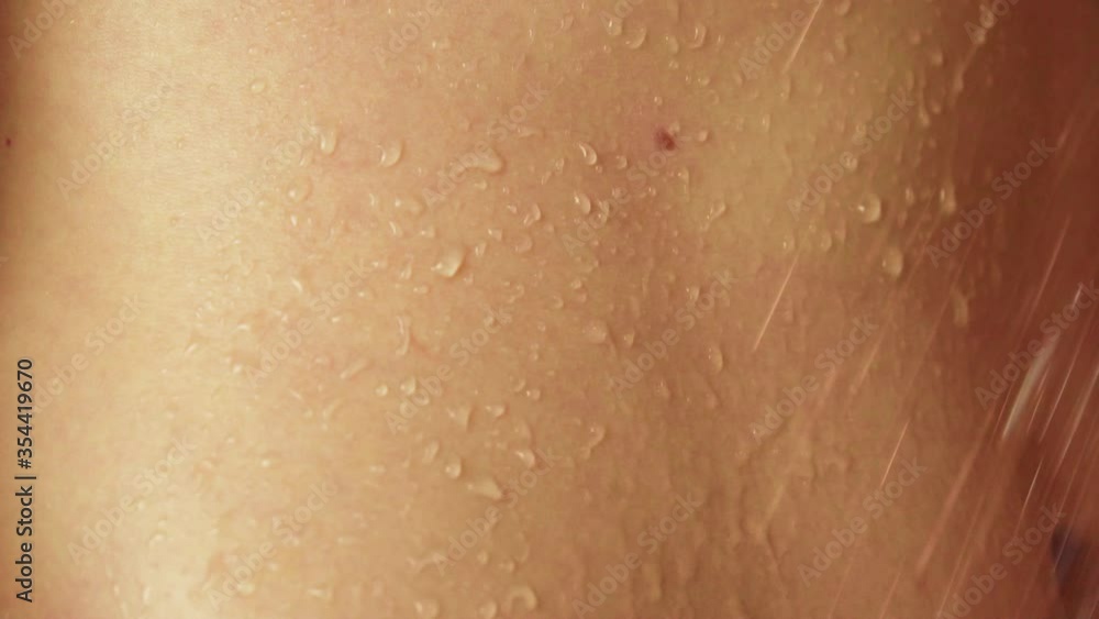 woman taking a shower in slow motion. a beautiful girl is washing and having fun in the shower, close-ups of her hands, back and chest drops drip over the skin. Close-up. woman taking a shower in slow motion. a beautiful girl is washing and having fun in the shower, close-ups of her hands, back and chest drops drip over the skin. Close-up.