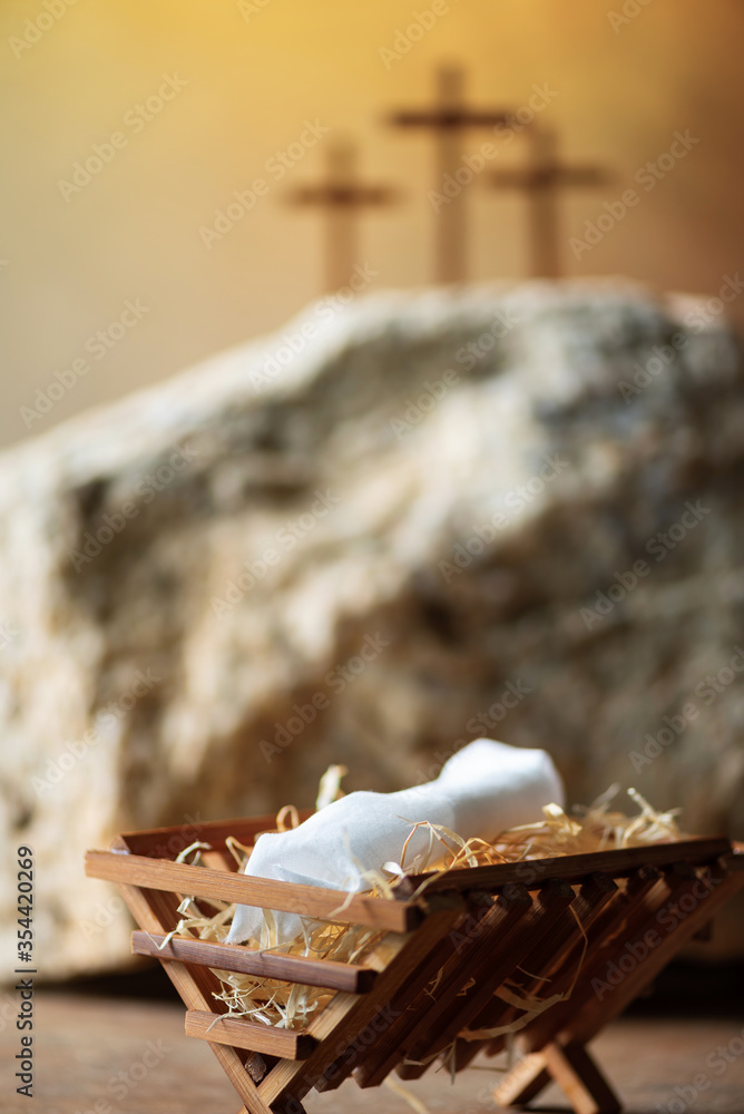 Obraz premium Wooden manger, three crosses background. Jesus - reason for season. Christian Christmas, Easter concept. Born to Die, Born to Rise. Salvation, Messiah, Emmanuel, God with us. Chronology of Jesus life