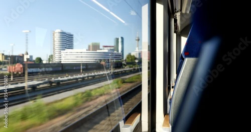 Sunny view of cityscape in Düsseldorf, Germany through window of moving train. Enjoy outdoor scenery moment during commute and travel by Train.