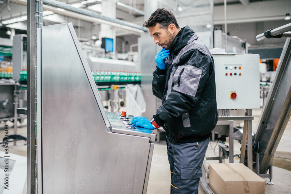 Male worker working in bottling factory. Inspection quality control. Male worker working in bottling factory. Inspection quality control.