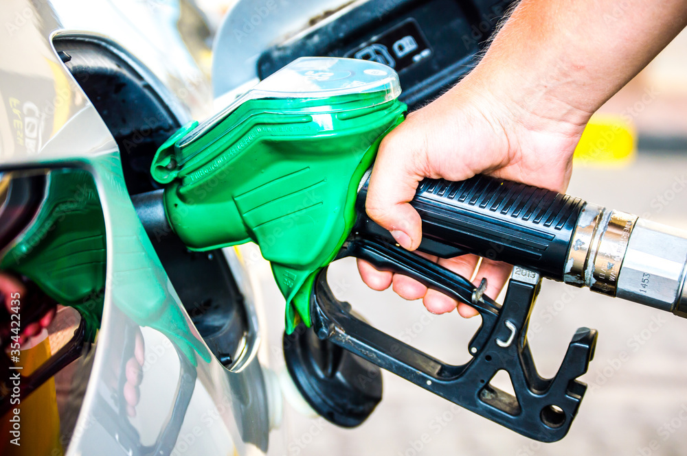Refueling new silver car. Fuel station. Transportation. Refueling new silver car. Fuel station. Transportation.