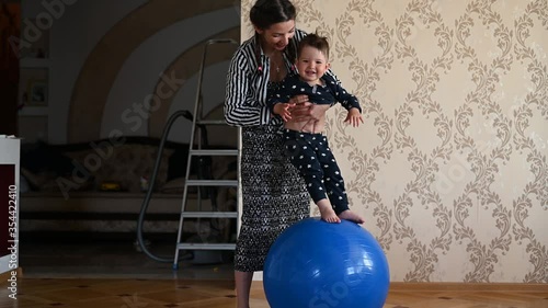 mom is doing exercises for the baby. Baby and mom develop body motility