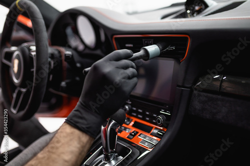 A man cleaning car interior, car detailing (or valeting) concept. Selective focus. © hedgehog94