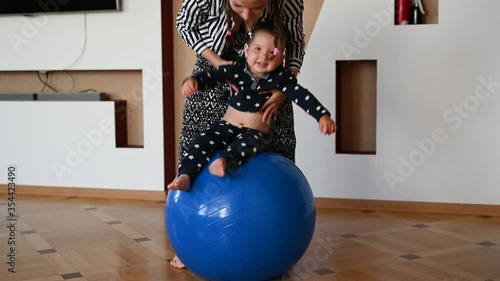 mom is doing exercises for the baby. Baby and mom develop body motility