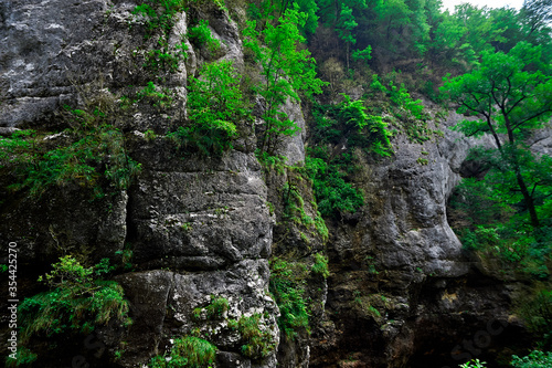 A large waterfall in a forest with Beng Mealea in the background