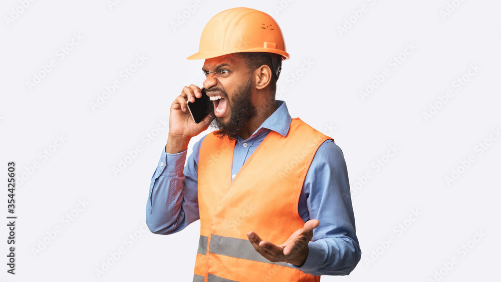 Angry Builder Yelling In Cellphone Standing In Studio, Panorama Angry Builder Yelling In Cellphone Standing In Studio, Panorama
