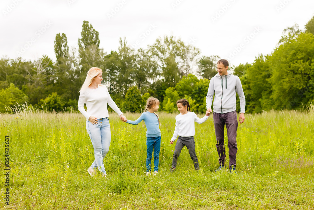 Fototapeta premium Family Enjoying Walk In Beautiful Countryside