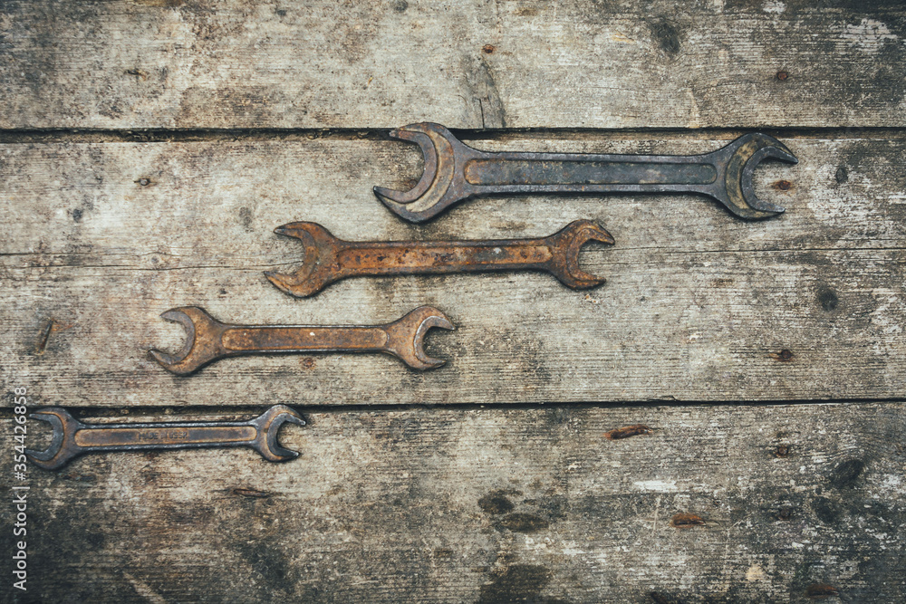 Rusty wrenches on a wooden background. Old keys Rusty wrenches on a wooden background. Old keys