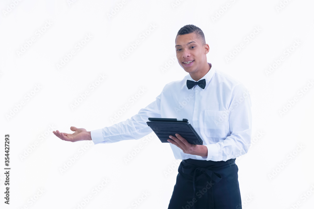 Waiter in a welcoming gesture holding a tablet Waiter in a welcoming gesture holding a tablet