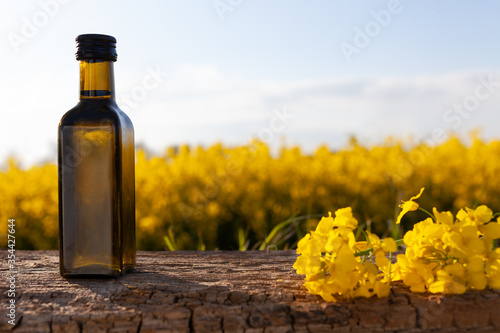 Oil bottle on the background of oilseed rape.