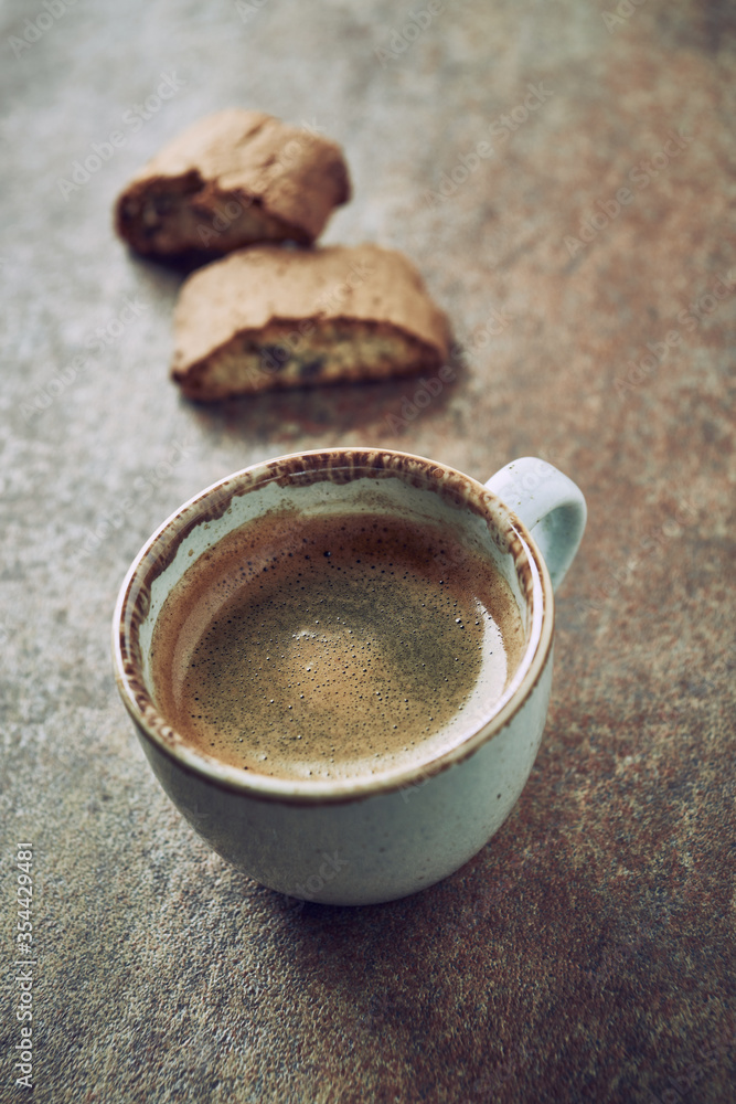 Cup of coffee with cantuccini (Italian biscuits) on rustic stone background. Cup of coffee with cantuccini (Italian biscuits) on rustic stone background.