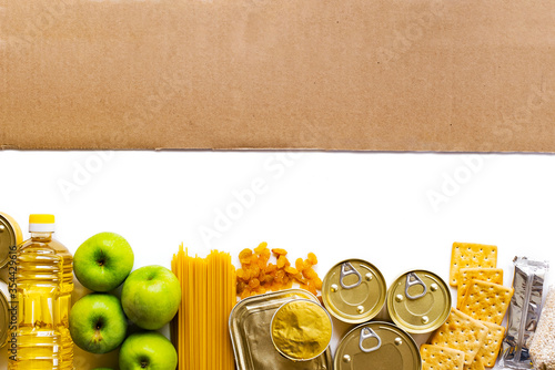 Food delivery, Donation. Food supplies crisis food stock for quarantine isolation period on white background. Pasta, canned food, apples, oil, crackers.