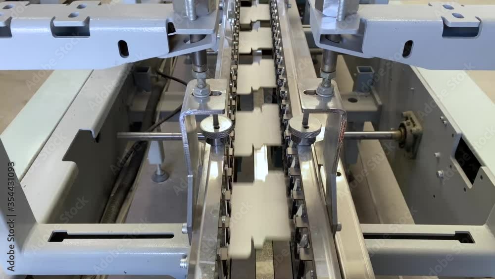 Printing press gluer in operation. Industry concept. Printing press gluer in operation. Industry concept.