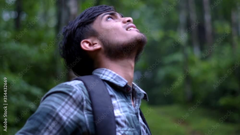 young indian man enjoying himself in the wild orbit shot trees forest hike trail young indian man enjoying himself in the wild orbit shot trees forest hike trail