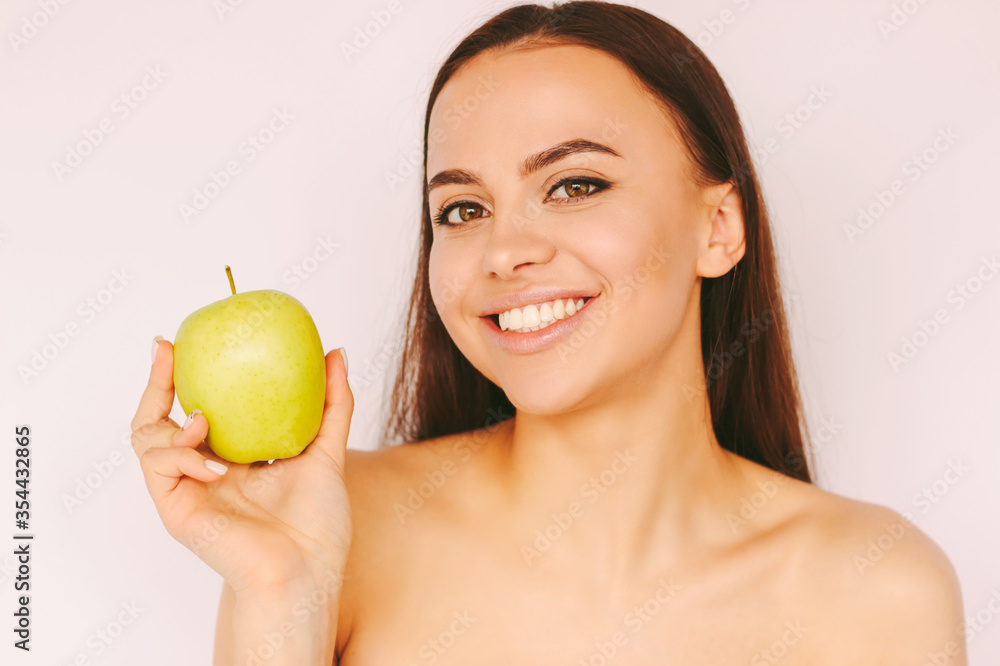 Portrait beautiful happy girl have fun and posing with green apple isolated on white background. Attractive young woman hold apple fruit in hand and smile. Healthy lifestyle, diet, cosmetology, detox Portrait beautiful happy girl have fun and posing with green apple isolated on white background. Attractive young woman hold apple fruit in hand and smile. Healthy lifestyle, diet, cosmetology, detox