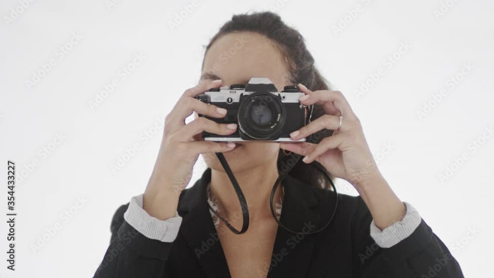 Attractive young brunette with brown eyes pointing camera objective at viewer and turning camera to take the best picture. 4K footage. Attractive young brunette with brown eyes pointing camera objective at viewer and turning camera to take the best picture. 4K footage.