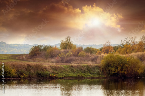 Picturesque sunset over the river in autumn
