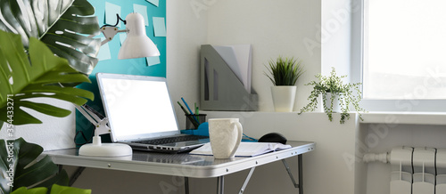 Home office workplace with laptop. Modern creative workspace at home. Banner photo