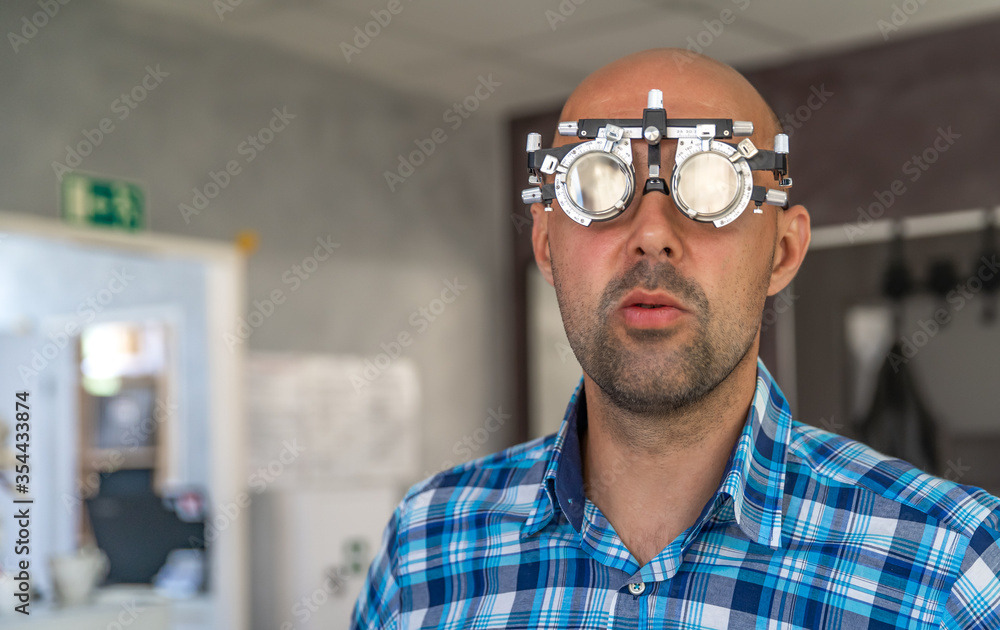 examination of the eyes of a man with special glasses, measurement of diopters in the eye surgery examination of the eyes of a man with special glasses, measurement of diopters in the eye surgery