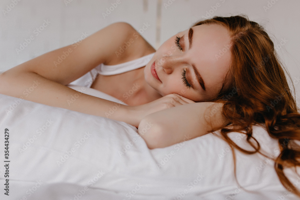 Sensual white girl with makeup sleeping on bed. Lovely romantic woman with curly hair relaxing in morning. Sensual white girl with makeup sleeping on bed. Lovely romantic woman with curly hair relaxing in morning.