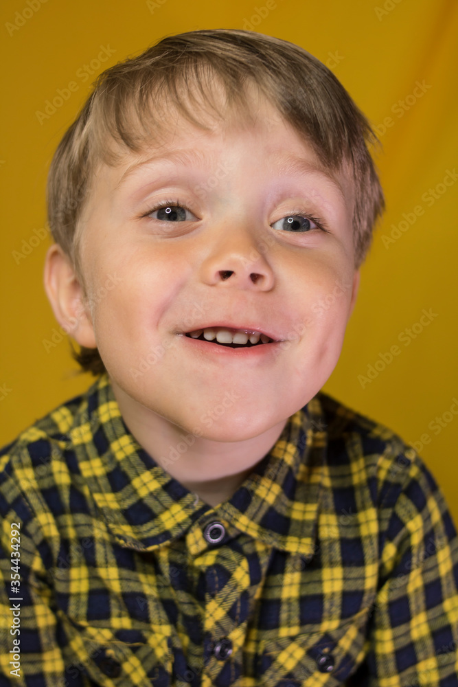 Baby with an incredible smile on a yellow background
Baby with an incredible smile on a yellow background