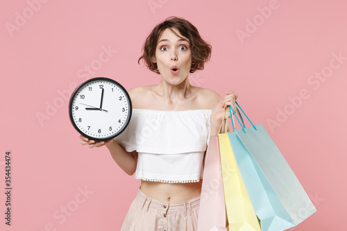 Photos Shocked amazed young woman girl in summer clothes isolated on pastel pink wall background studio portrait